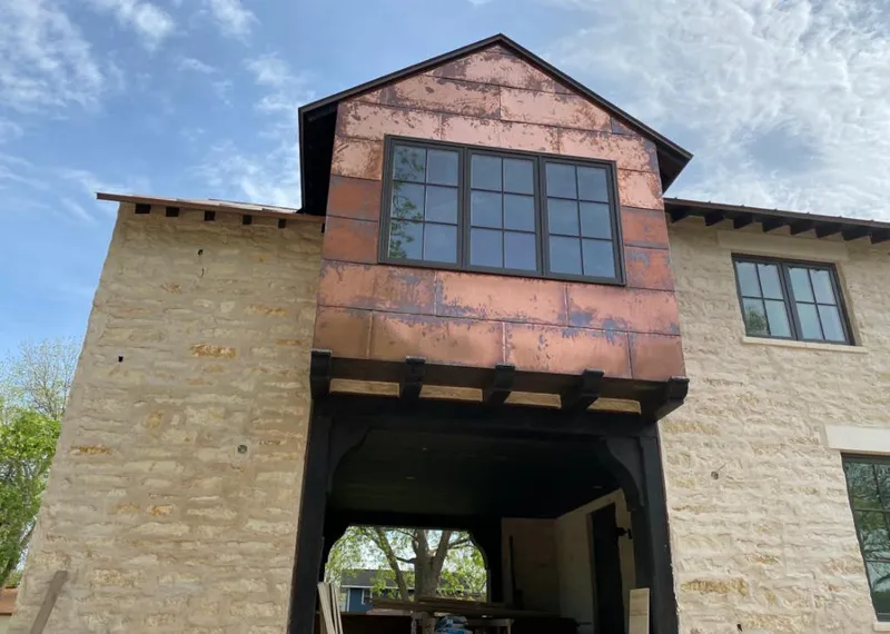 Copper metal panel facade on a stone building for Skylight Installation in Pewaukee