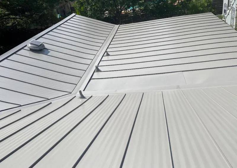 Solar attic fan installed on a metal roof for Roof Ventilation in Pewaukee